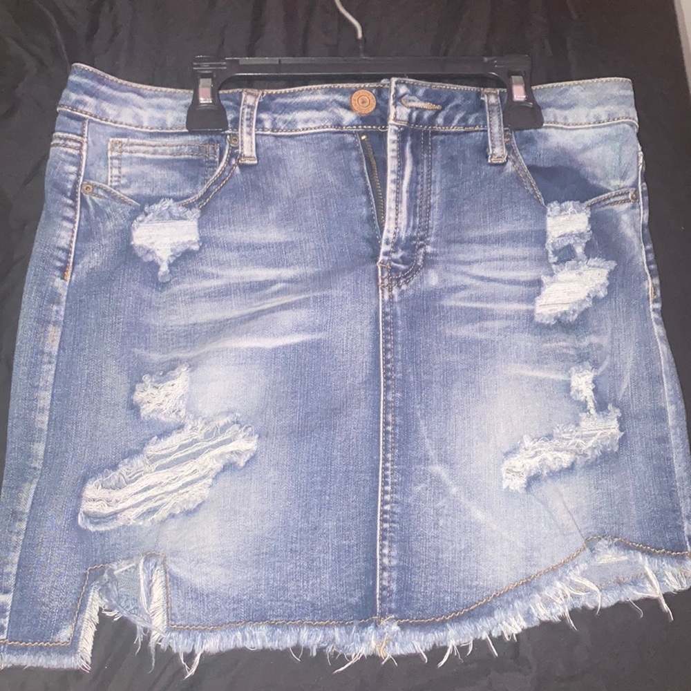 Short, jean skirt with rips.